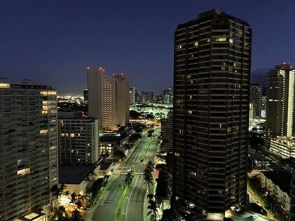 Downtown Honolulu lighting up the night sky with its city lights on Oahu in Hawaii. 