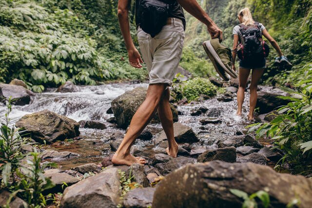 Close up of hikers walking along a stream with bare feet, the Great Smoky Mountains.
