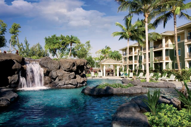 Goregous image, Suite balconies overlooking Palm trees and pool with waterfall, Kings' Land, a Hilton Grand Vacations Club, Big Island, Hawaii.