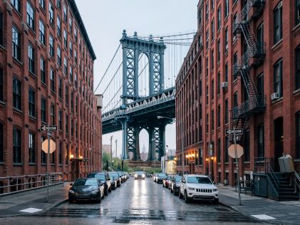 Manhattan Bridge in between two brick buildings in New York City