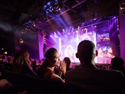 A woman turns to her partner while at a show in Las Vegas