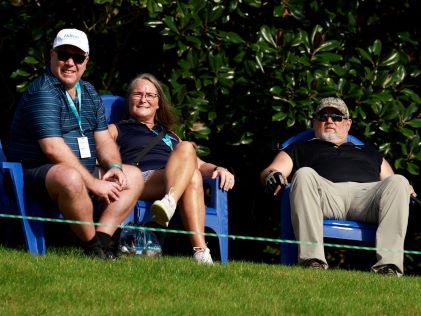 Two Members sitting with Larry the Cable Guy at the Hilton Grand Vacations Tournament of Champions