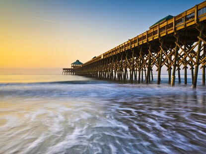 Shot of ocean and pier at Folly Beach in Charleston, South Carolina. 