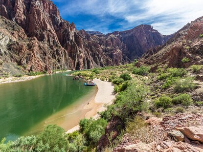 Aerial shot of a lake and raft in Grand Canyon National Park in Arizona.