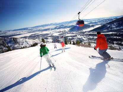Downhill skiers enjoy fresh powder in Breckenridge, Colorado.