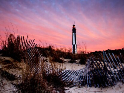 Pink and purple sunset skies above Cape Henry Lighthouse, Virginia Beach, Virgina. 