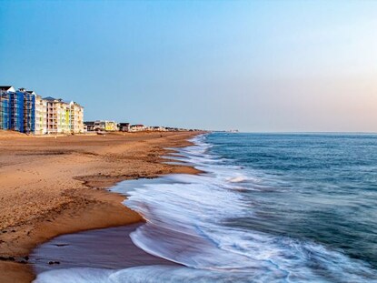 Blue Atlantic ocean waters washing ashore golden sands, Sandbridge Beach, Virginia.